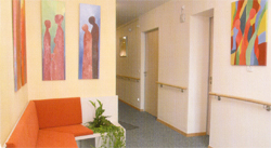 Wir befinden uns im Koridor des Hoapizes. Links sehen wir eine Kommunikationsecke. Ein rotes Sofa l�t zum Verweilen ein. Rechts schlie�t sich ein Gang mit Zimmert�ren an.